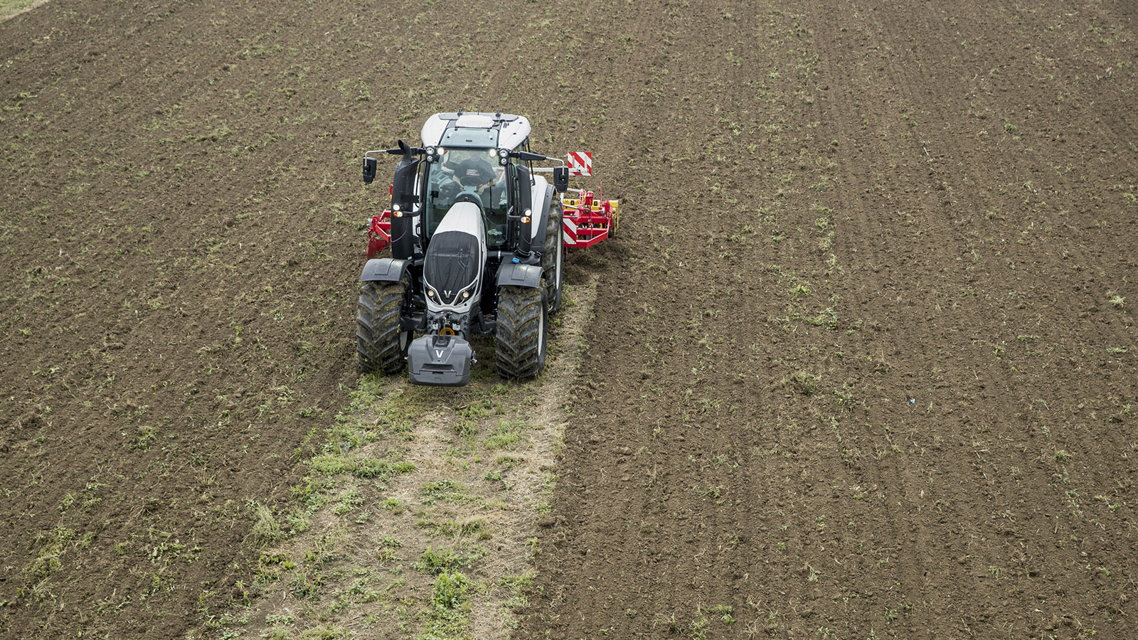 valtra t series tractor farm machinery on the field working 